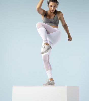 young-woman-doing-exercises-with-her-headphones